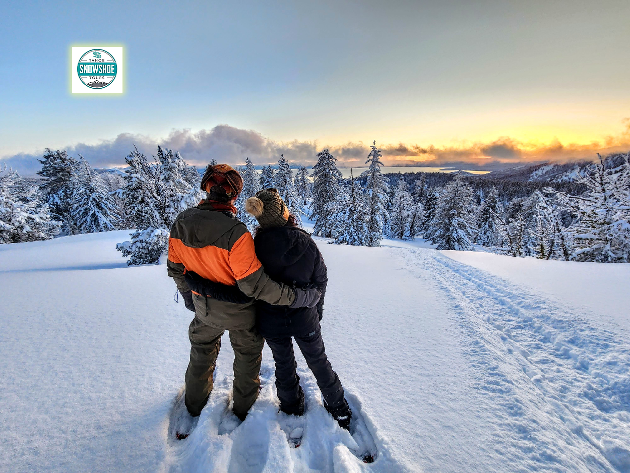 Couple snowshoeing with sunset views above Lake Tahoe