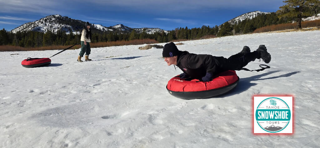 Group enjoying snow tubing on a snowy slope in Lake Tahoe.