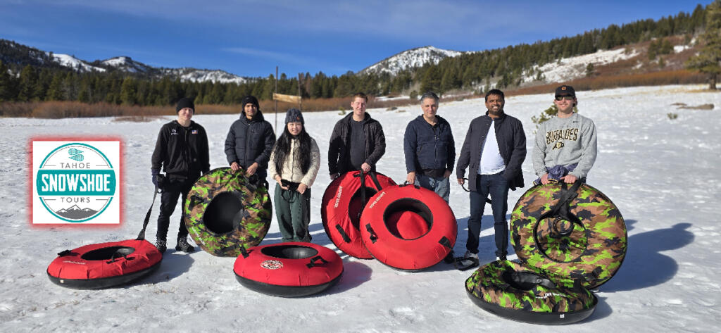 Group enjoying snow tubing on a snowy slope in Lake Tahoe.